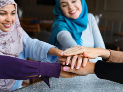 Islamic women with their hands on top of each other